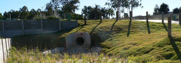 Completed stormwater outlet and headwall with stabilised batter on a finished subdivision